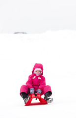 Fototapeta na wymiar sledding little girl
