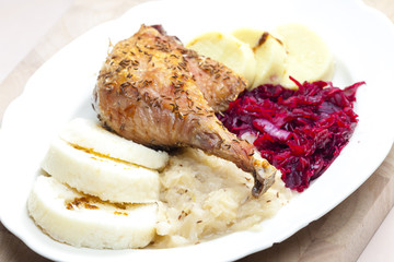 baked duck meat with dumlings and cabbage