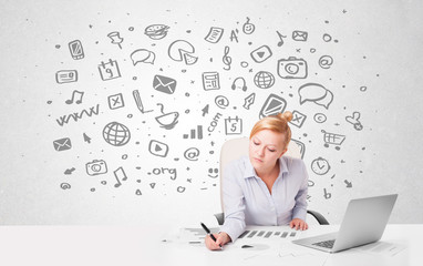 Young businesswoman with all kind of hand-drawn media icons in b