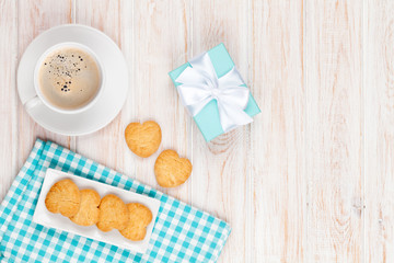 Cup of coffee, heart shaped cookies and gift box