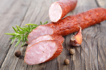 Delicious smoked sausage, sliced on a wooden board