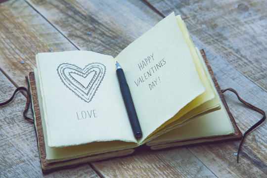 Old paper sketch book with hand-drown heart. Happy Valentines!