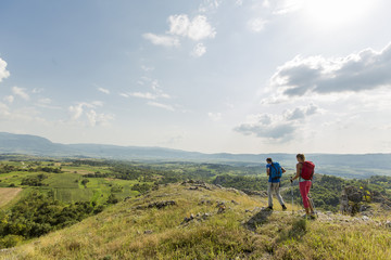 Fototapeta premium Young couple hiking on the mountain
