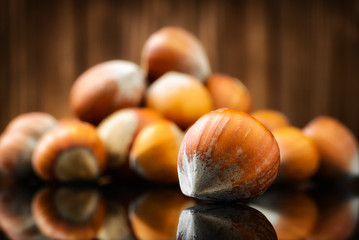 Raw Organic Whole Hazelnuts on wooden background. Selective