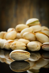 Pistachios on wooden table. Selective focus