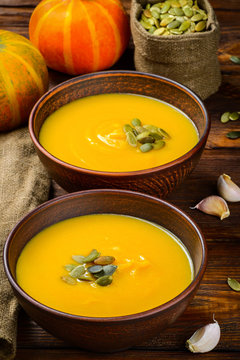 Pumpkin soup on rustic wooden table, selective focus