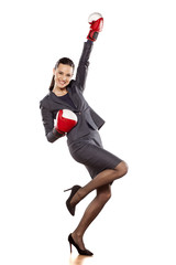Happy business woman with boxing gloves in winning position