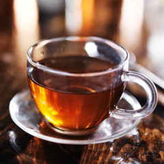 cup of hot tea on wooden table shot with selective focus