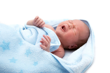 One week old crying baby in a blanket on white background