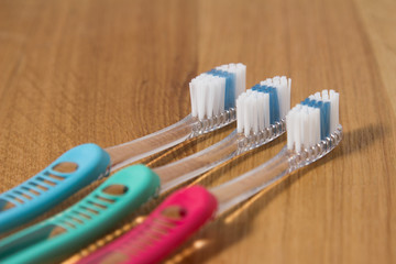 Row of three new tooth brushes