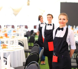 Large group of waiters and waitresses standing