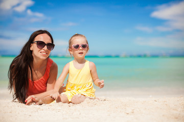 Fototapeta premium Little girl and happy mom having fun at exotic beach on sunny