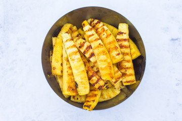 Fried pineapples on plate outdoors on snow