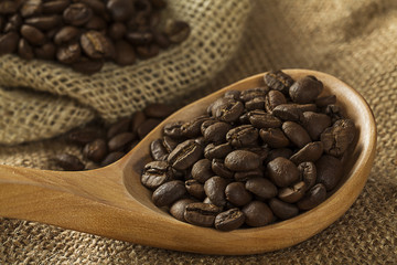 Coffee beans on burlap sack and spoon