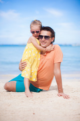 Happy father and his adorable little daughter at tropical beach