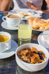 Delicious breakfast with flakes,dried fruit and cup of hot