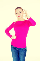 Young casual woman showing perfect sign.