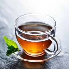 glass of hot tea with mint garnish