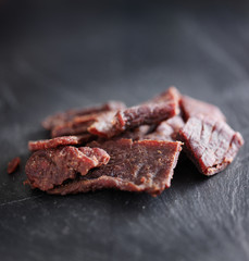 beef jerky in a pile on slate surface