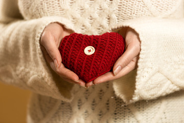 Closeup photo of woman holding heart in hands