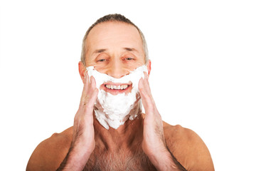 Portrait of a man applying shaving foam