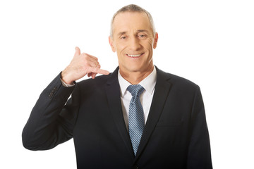 Portrait of businessman with call me gesture