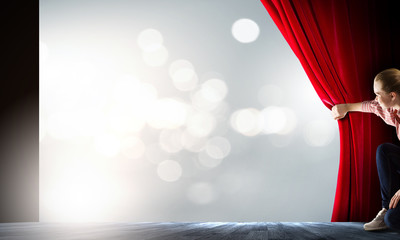 Girl opening curtain