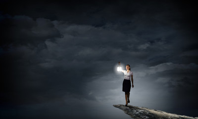 Businesswoman with lantern