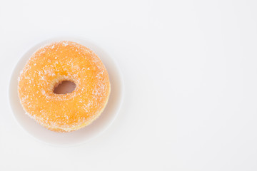Obraz na płótnie Canvas Delicious Sugar Ring Donut with a White paper Background