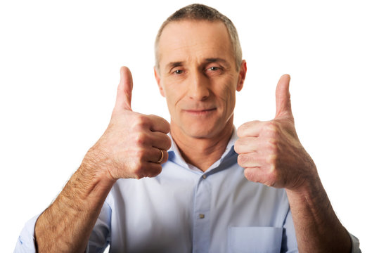 Portrait of mature man gesturing ok sign