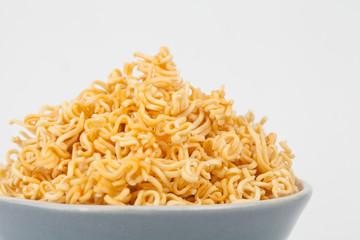 A block of dried Instant noodles on dish with gray background