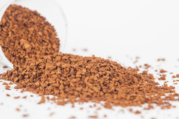 Instant coffee powder in glass with white paper background