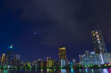 Fototapeta na wymiar Tokyo riverside cityscape at night.
