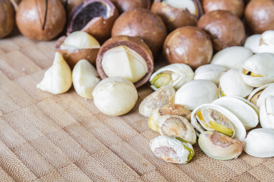 Macadamia and Pistachio nut on wood table.