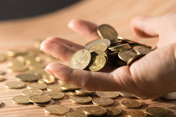 coins on the table and in hand
