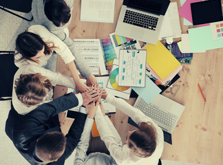 Business team with hands together - teamwork concepts