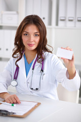female doctor holding an empty card, isolated on white