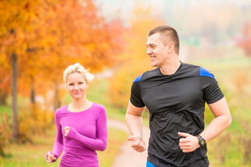 healthy lifestyle - jogging. a man and a woman running in the mo