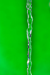 a jet of water on a green background
