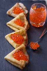 Pancakes with red caviar.