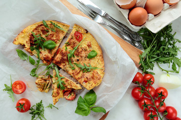 Omelet with fresh rucola salad and tomatoes