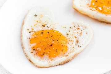 Fried eggs in the form of heart, close-up, selective focus