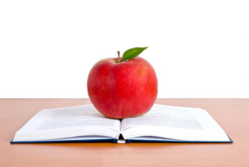 a opened student book with red apple