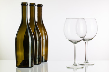 Empty bottles of wine on a glass desk