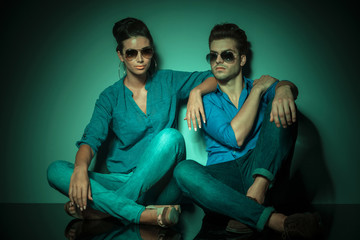 fashion couple resting on studio background