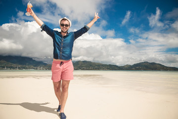 Happy man on the beach looking at the camera