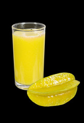 starfruit and juice isolated on black