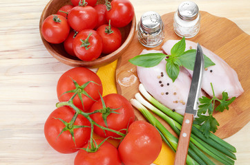 Raw chicken breasts on cutting board