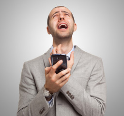 Desperate man holding his mobile phone