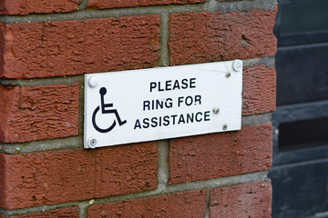Fototapeta na wymiar Please ring for assistance sign for wheelchair users